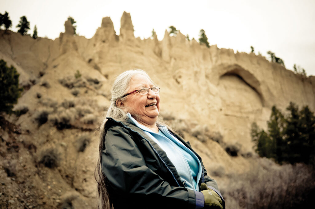 A woman standing in front of the hoodoos.